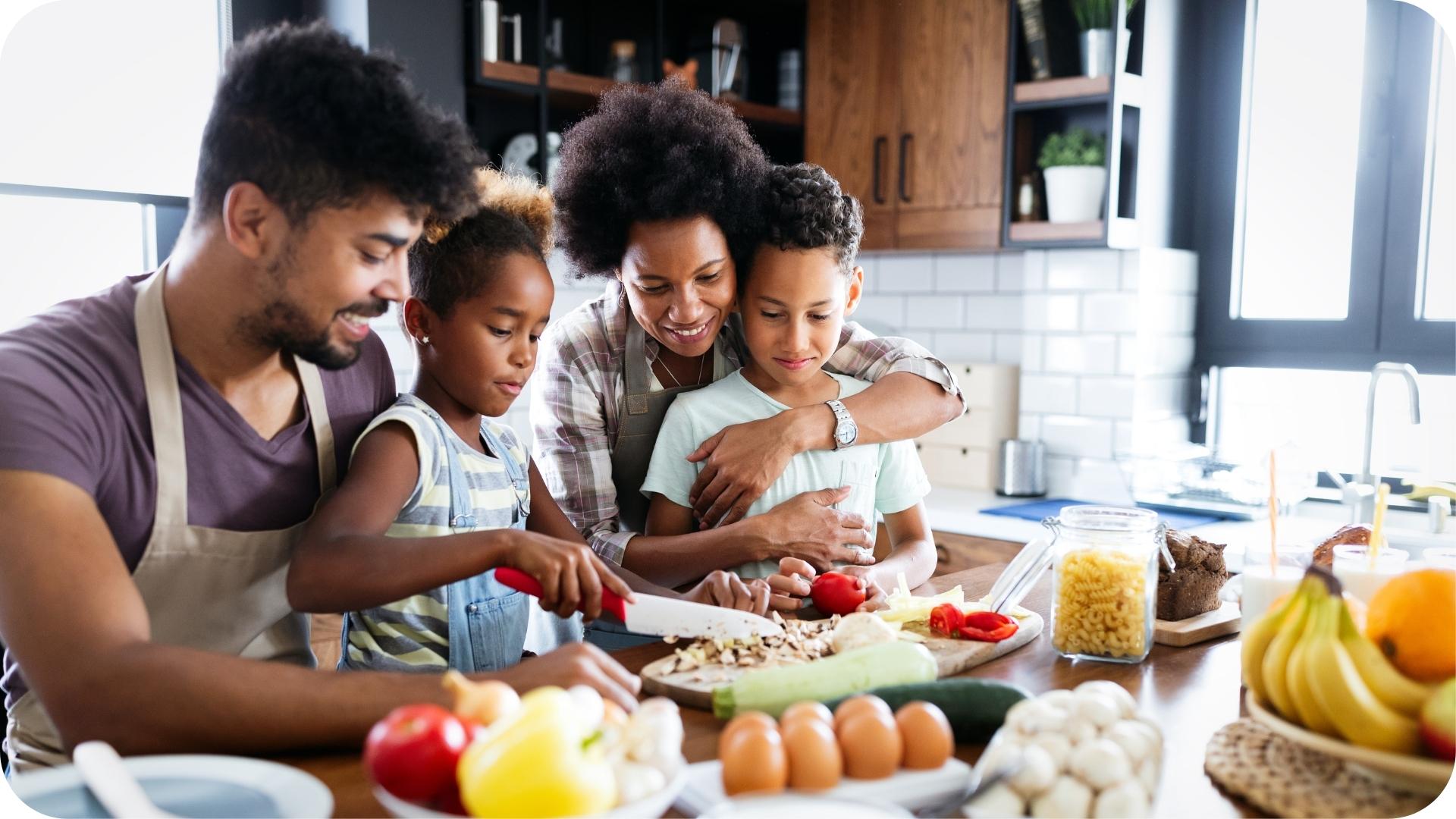 Family preparing a meal together in the kitchen with fresh vegetables and healthy ingredients